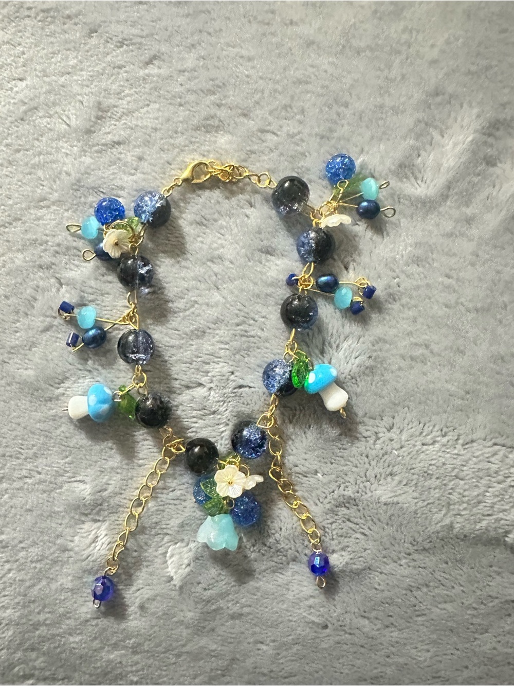 Handcrafted Blue Gold Charm Bracelet with Floral Accents